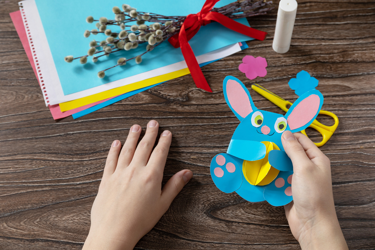 A Child Is Holding an Easter Bunny Toy Card with Easter Egg. Han